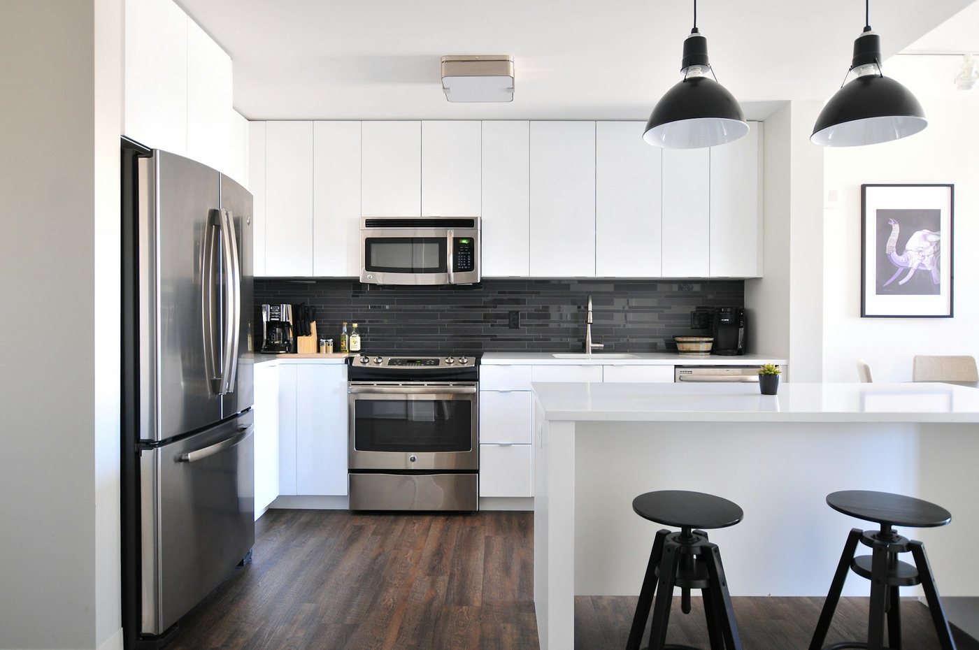 Renovated apartment kitchen with new cabinets and stainless appliances